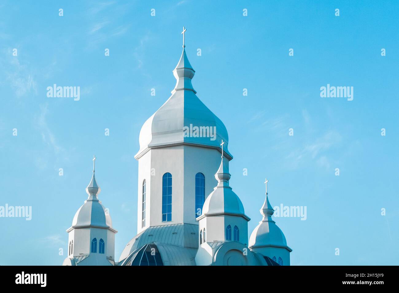 Modern church religious architecture Christian building against the blue sky. Stock Photo