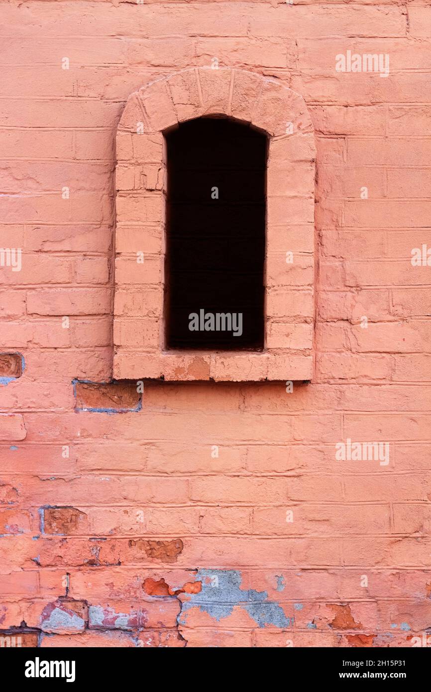 Photo of old and cracked red colored brick wall with arched window ...