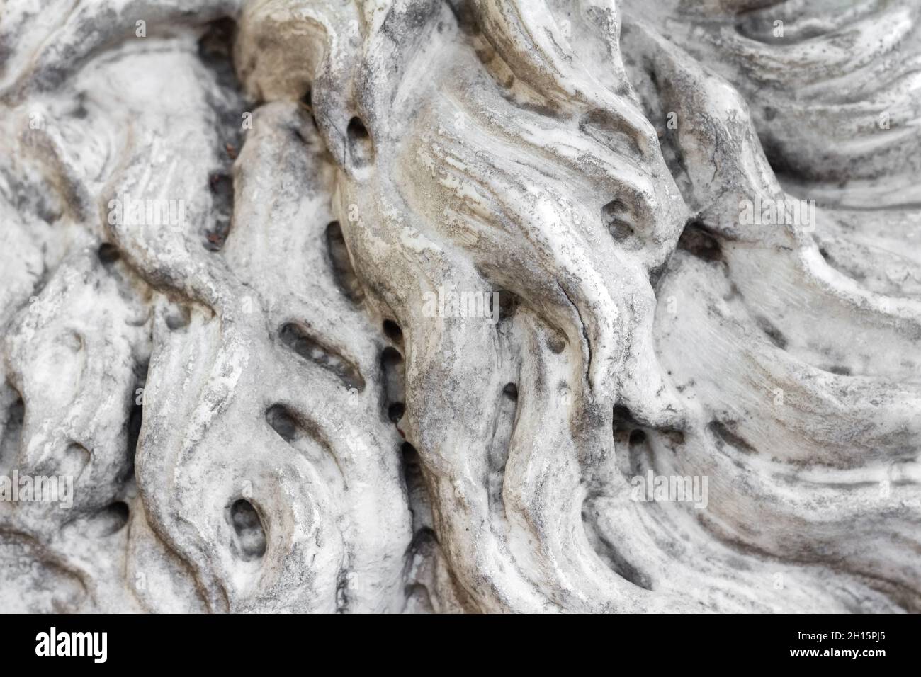 Close-up photo texture of worn marble statue hair pattern. Stock Photo