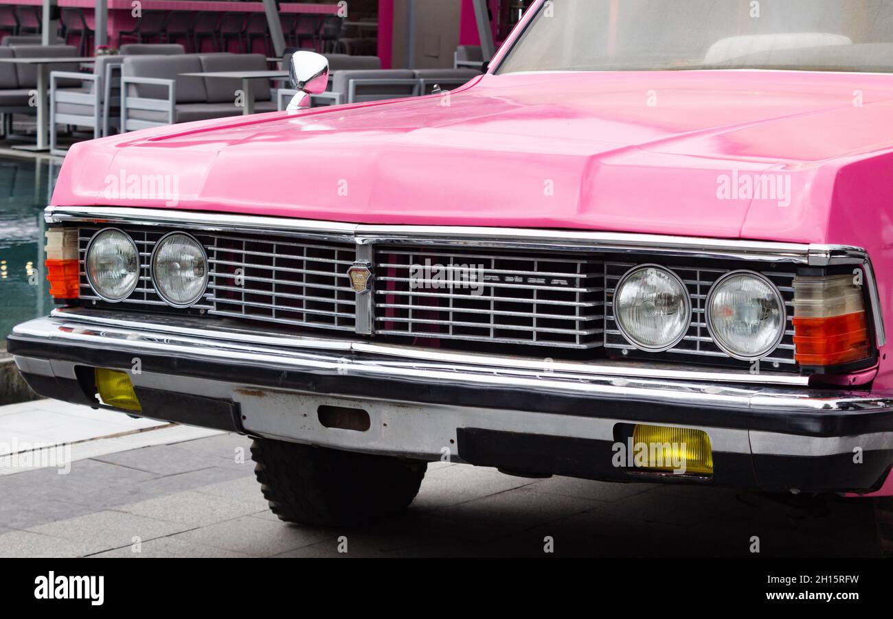 Odessa, Ukraine- September 15, 2021: Retro pink colored model Chaika car parked on street. Stock Photo