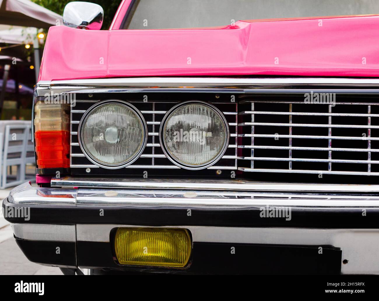 Odessa, Ukraine- September 15, 2021: Retro pink colored model Chaika car headlights close-up photo. Stock Photo