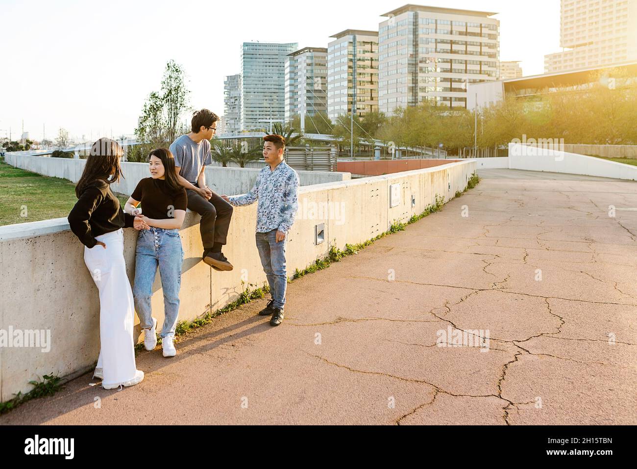 Group of asian people from different countries talking in the street at sunset  Stock Photo