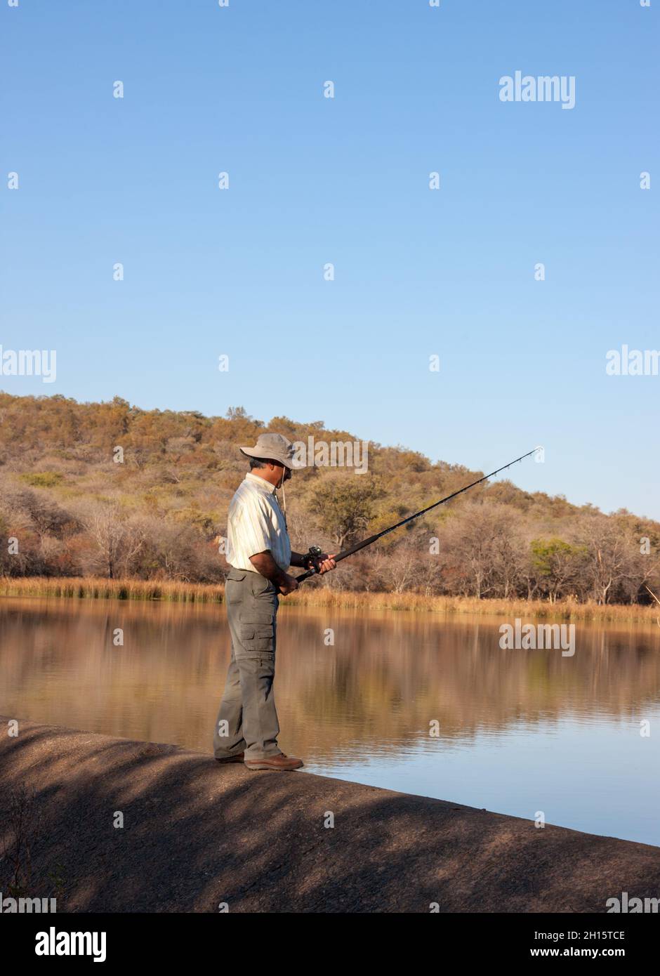 Portrait of an Iranian Arabic man  with a moustache gone in holiday fishing by the lake Stock Photo