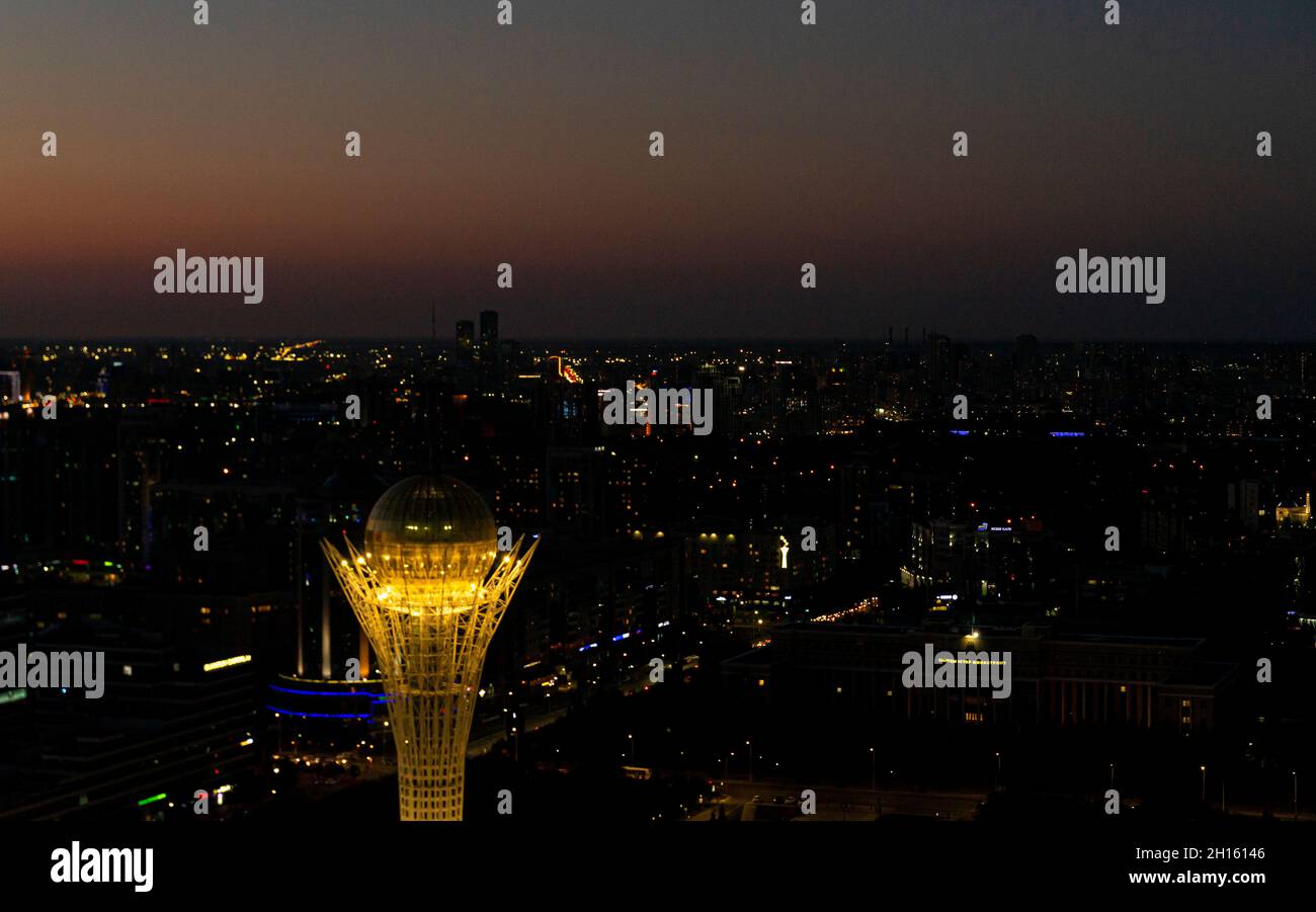 Dusk top aerial view of the city with Baiterek tower, architect Norman Foster; lit up at night, Astana, Nur-Sultan, Kazakhstan, Central Asia Stock Photo