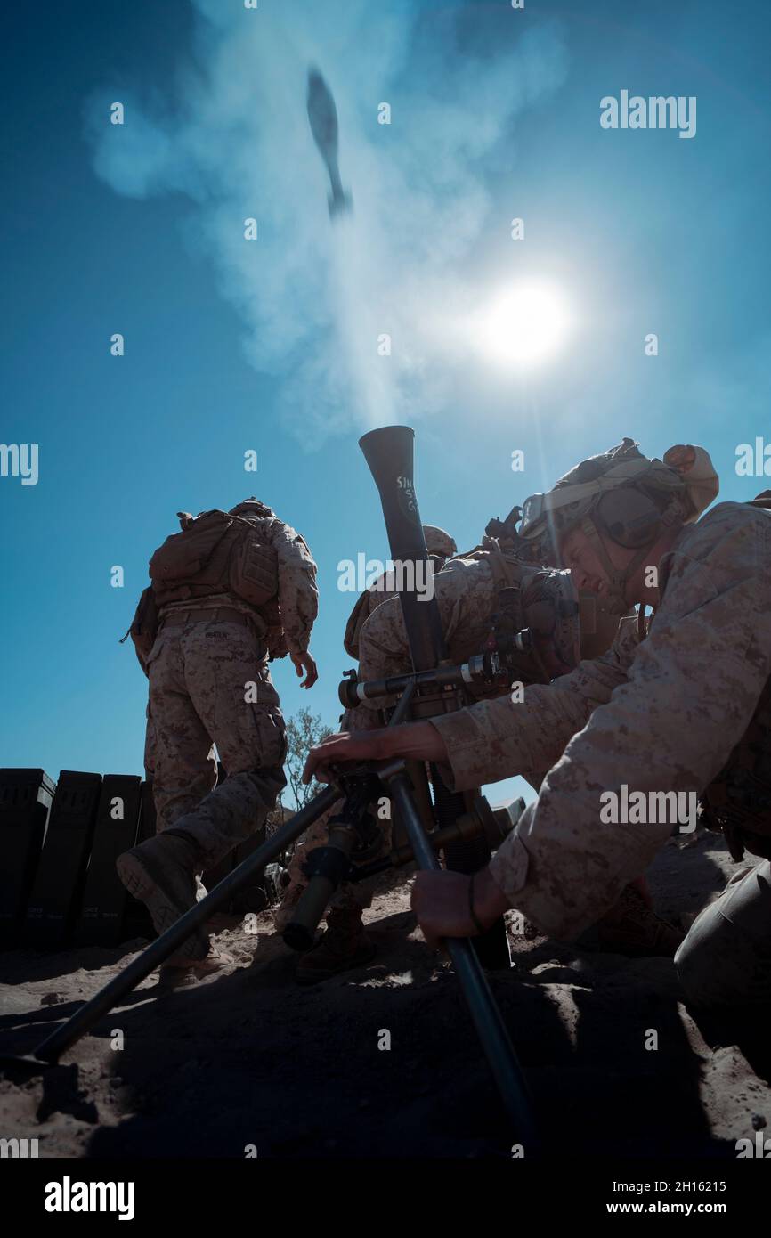 U.S. Marines with 1st Battalion, 3d Marines, 3d marine Division, fire an M252 81mm mortar system during a simulated enemy counterattack as part of the Battalion Distributed Operations Course during Service Level Training Exercise 1-22 at Marine Corps Air Ground Combat Center Twentynine Palms, California, Oct. 14, 2021. BDOC allows 1st Battalion, 3d Marines to command and control multiple maneuver elements while integrating ground and aviation delivered ordinance to successfully secure an objective. (U.S. Marine Corps photo by Cpl. Juan Carpanzano) Stock Photo