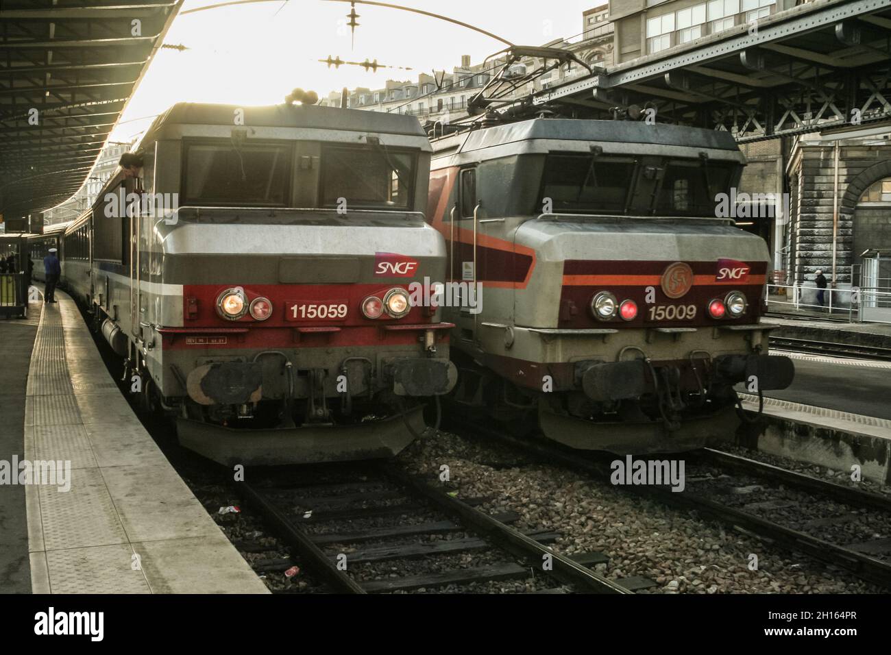 PARIS, FRANCE - JANUARY 2, 2007: Two electric locomotives BB 15000 ready for departure in Paris Gare de l'Est train station at dusk, with the logo of Stock Photo