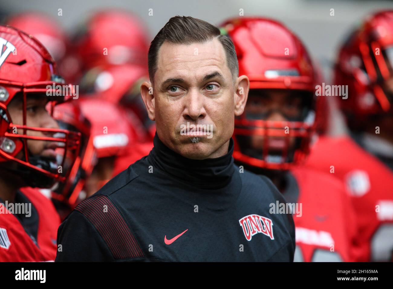 October 16, 2021: UNLV Rebels head coach Marcus Arroyo waits to be  introduced prior to the start of the NCAA football game featuring the Utah  State Aggies and the UNLV Rebels at
