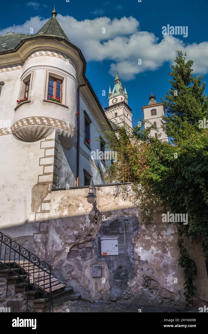 Renaissance mansion in Kremnica with turret like tower in the city of gold in Slovakia with imposing castle church bell tower in the background Stock Photo