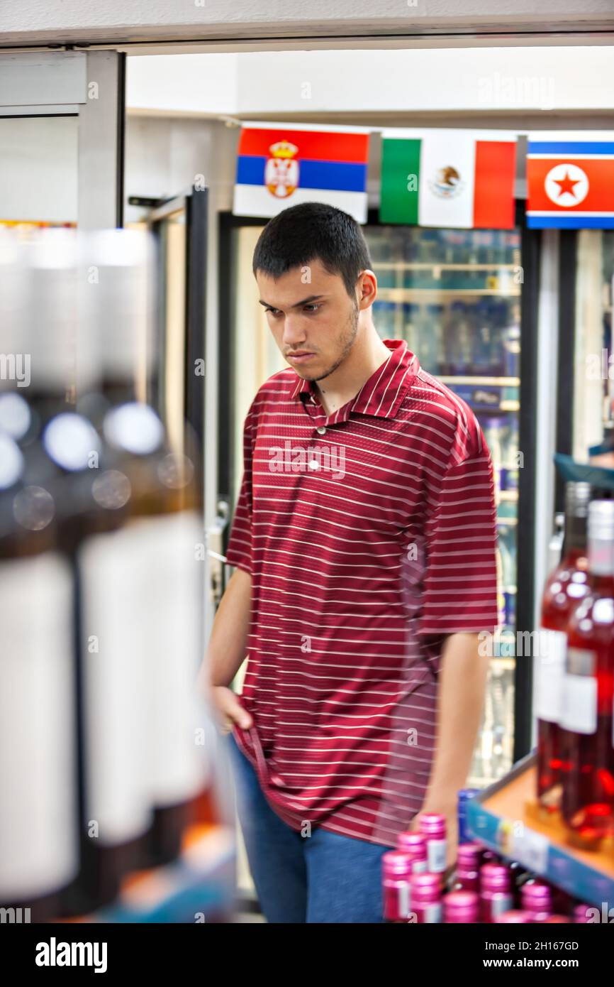 teenager with a t-shirt portrait , shopping in a supermarket Stock Photo