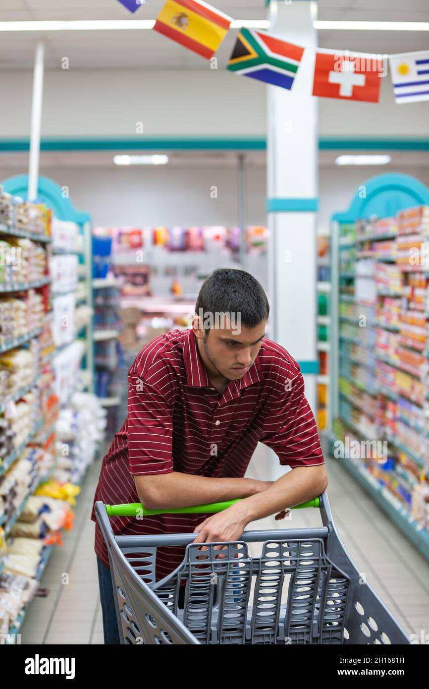 teenager with a t-shirt portrait , shopping in a supermarket Stock Photo