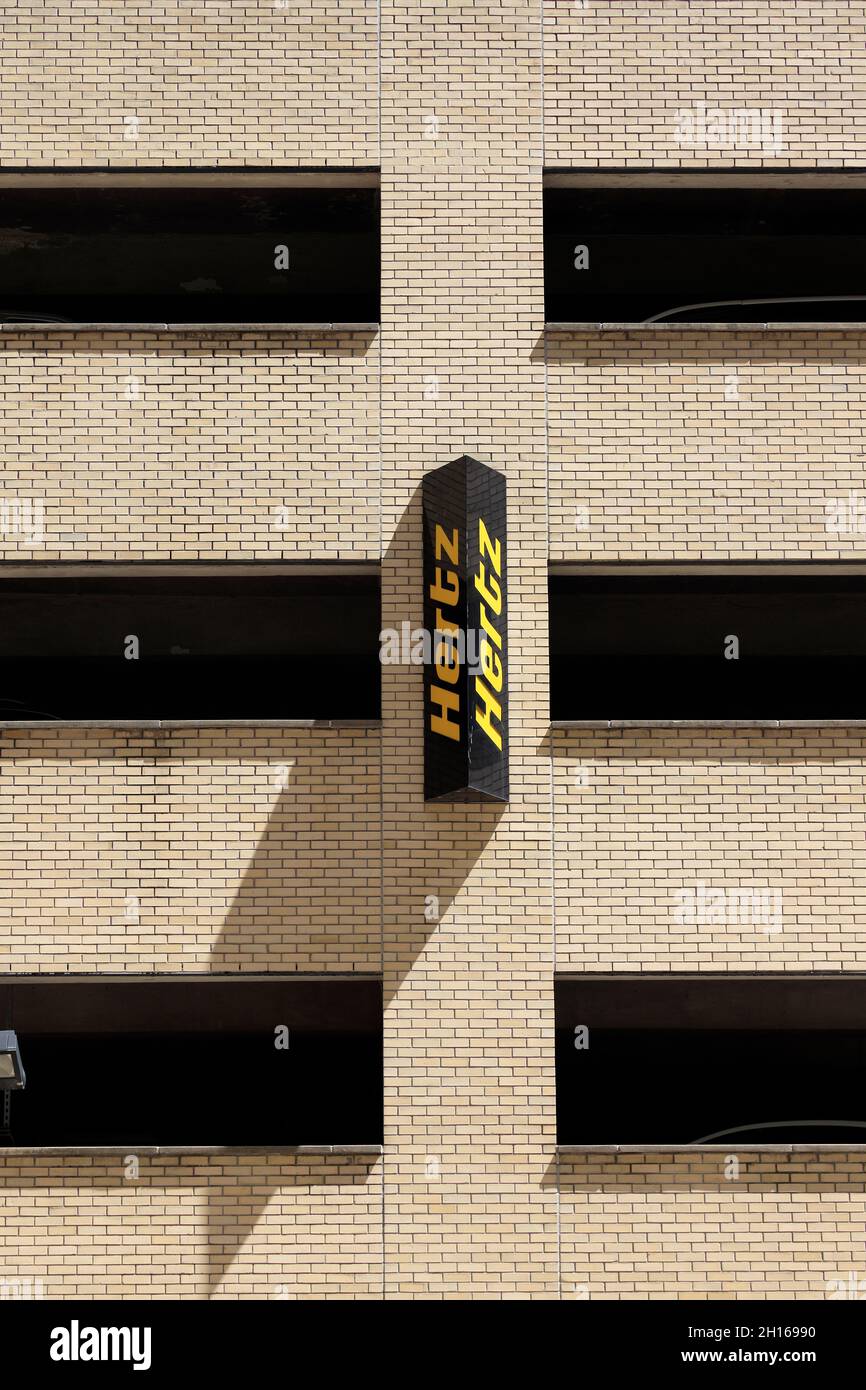 The sign of Hertz car rental company on a parking garage on 34th street