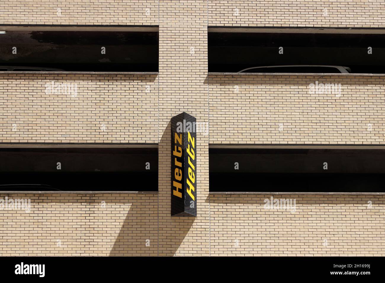 The sign of Hertz car rental company on a parking garage on 34th street