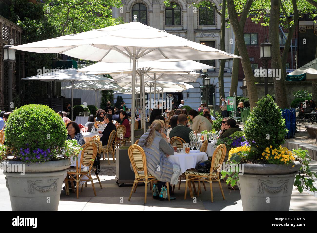 Customers at the outdoor seating of Bryant Park Grill and Cafe in Bryant Park.New York City.USA Stock Photo
