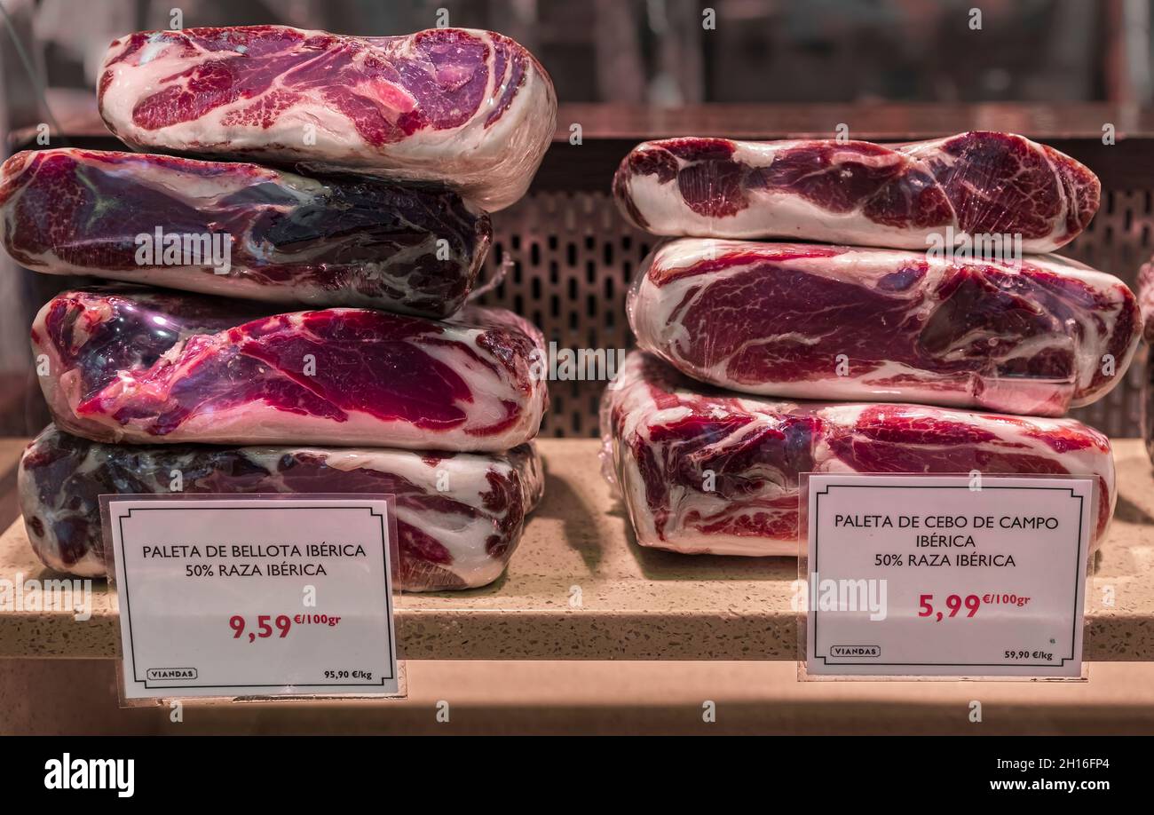 Carved pieces of Spanish serrano iberico ham for sale at a local butcher shop in the old town or Casco Viejo in Pamplona Spain Stock Photo