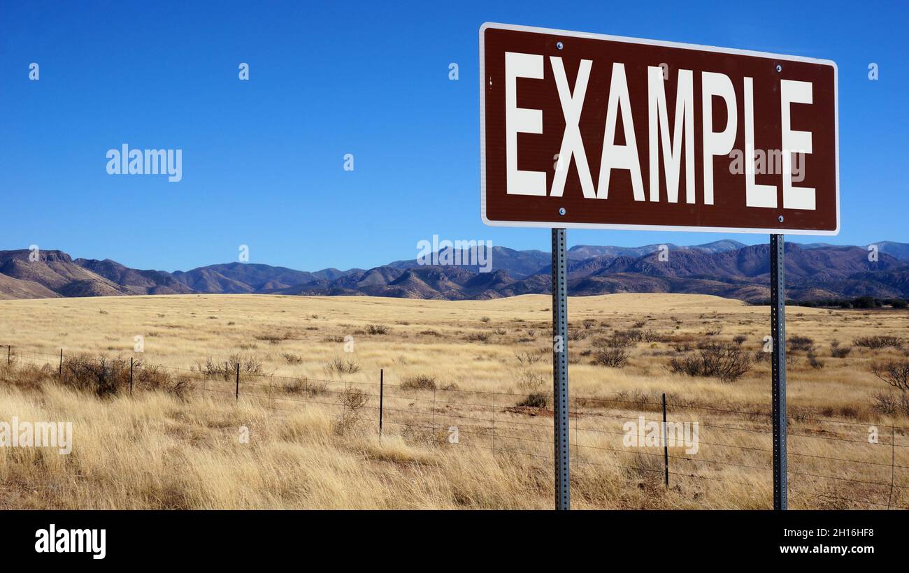 Example word on road sign and blue sky Stock Photo - Alamy