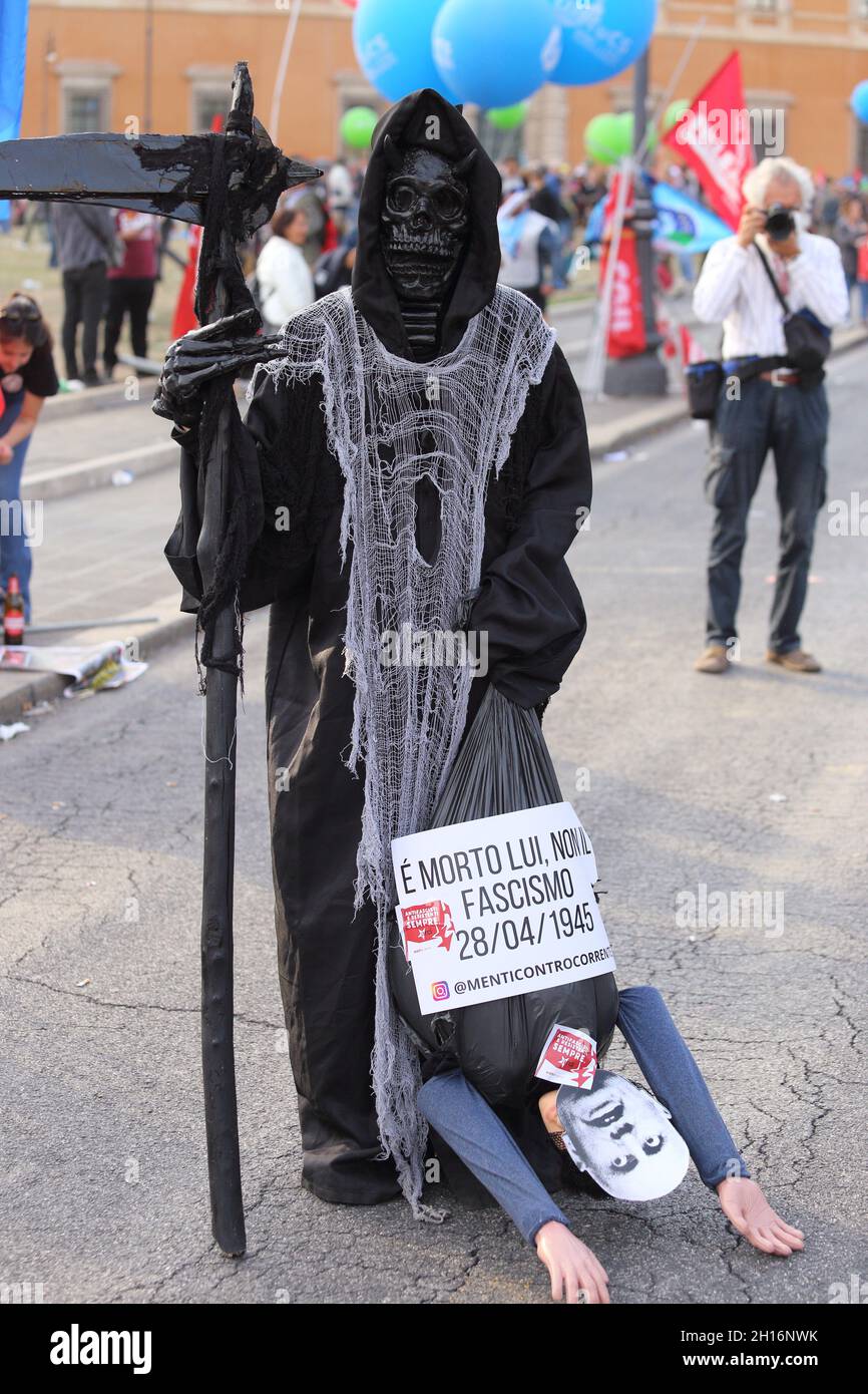 Rome Italy. October 16, 2021. A man disguised as death during the anti-fascist demonstration in Piazza San Giovanni is walking dragging a puppet with the face of the dictator Benito Mussolini and the words 'he died, not fascism' Stock Photo
