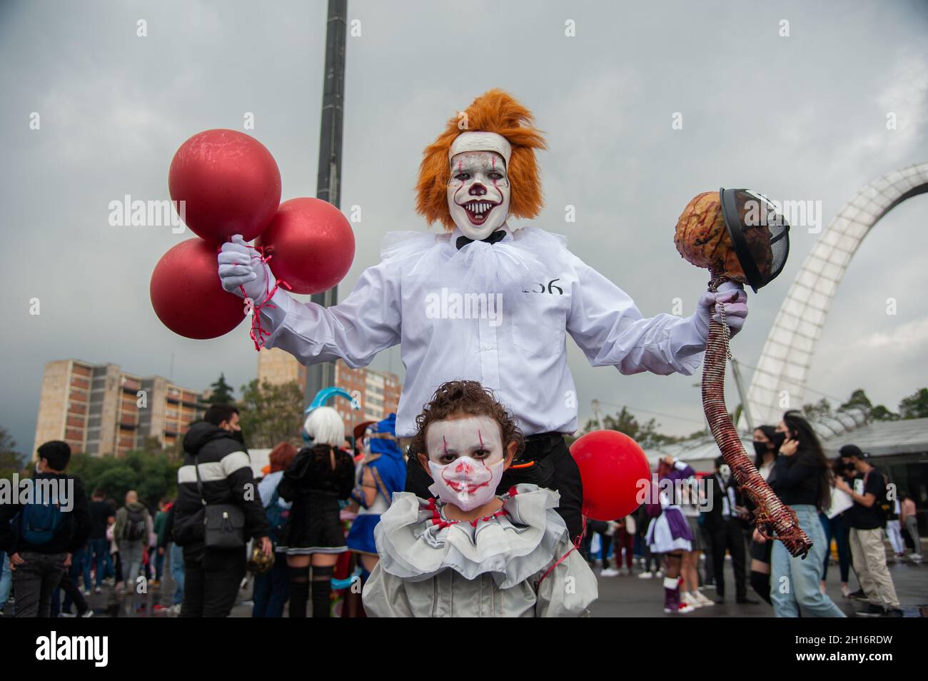 A child cosplaying Pennywise takes a photo with another cosplayer using the  same costume during the first day of the SOFA (Salon del Ocio y la  Fantasia) 2021, a fair aimed to