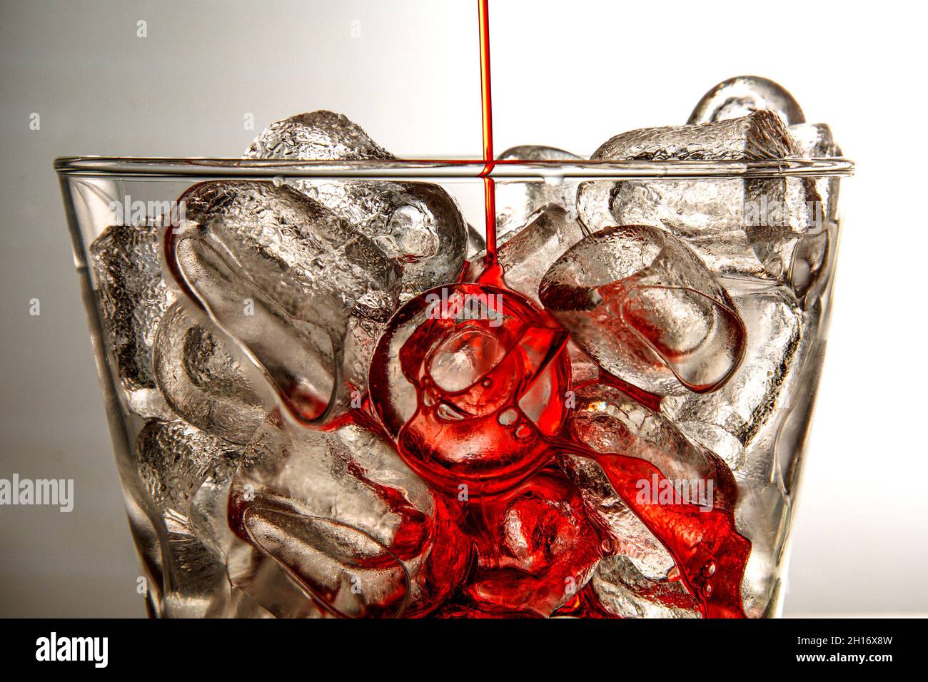 ice cubes in a glass with red liquid Stock Photo