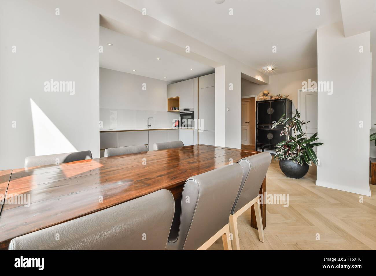Modern dining room and kitchen interior with table and chairs against ...