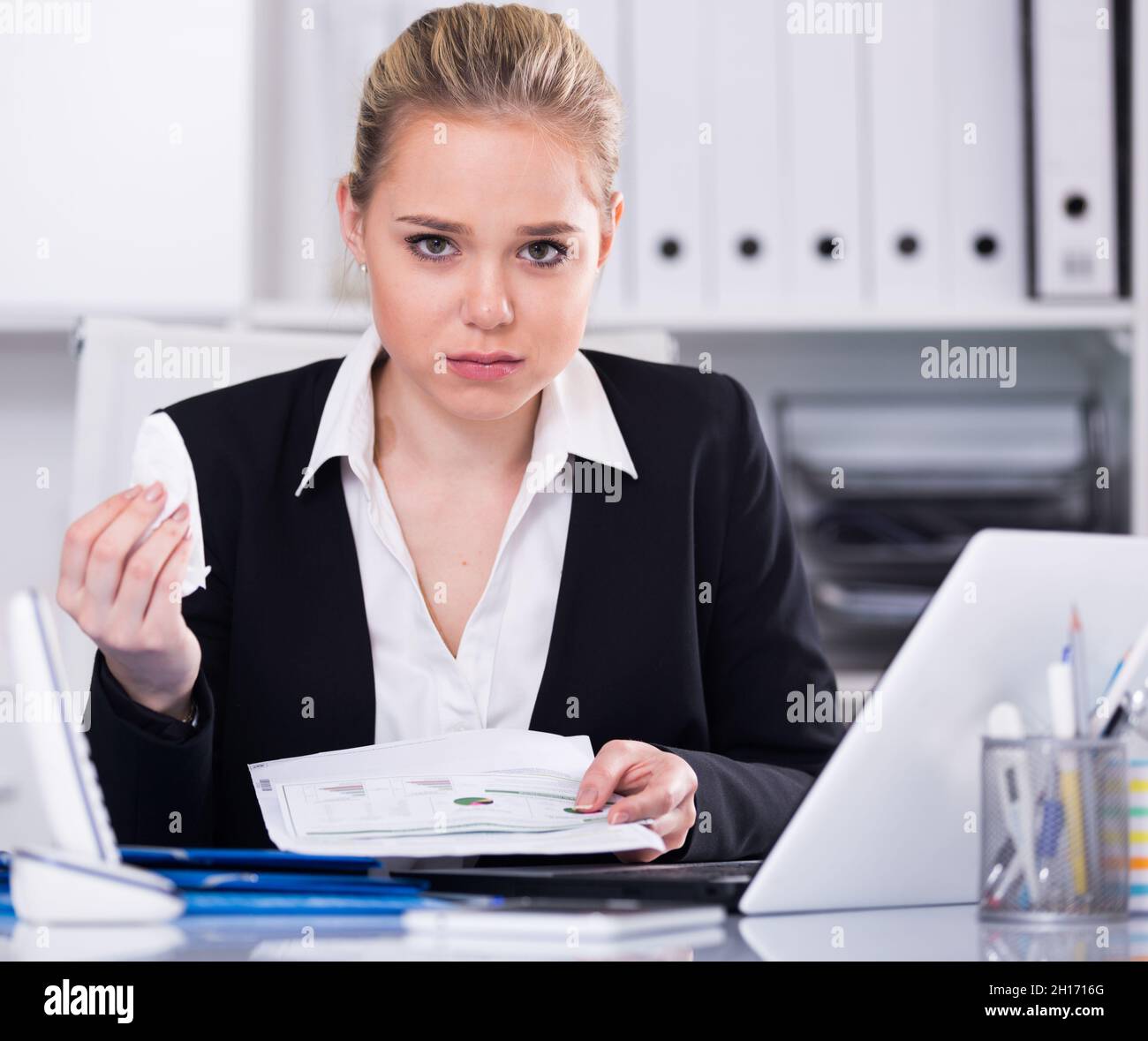 Frustrated business woman with papers Stock Photo
