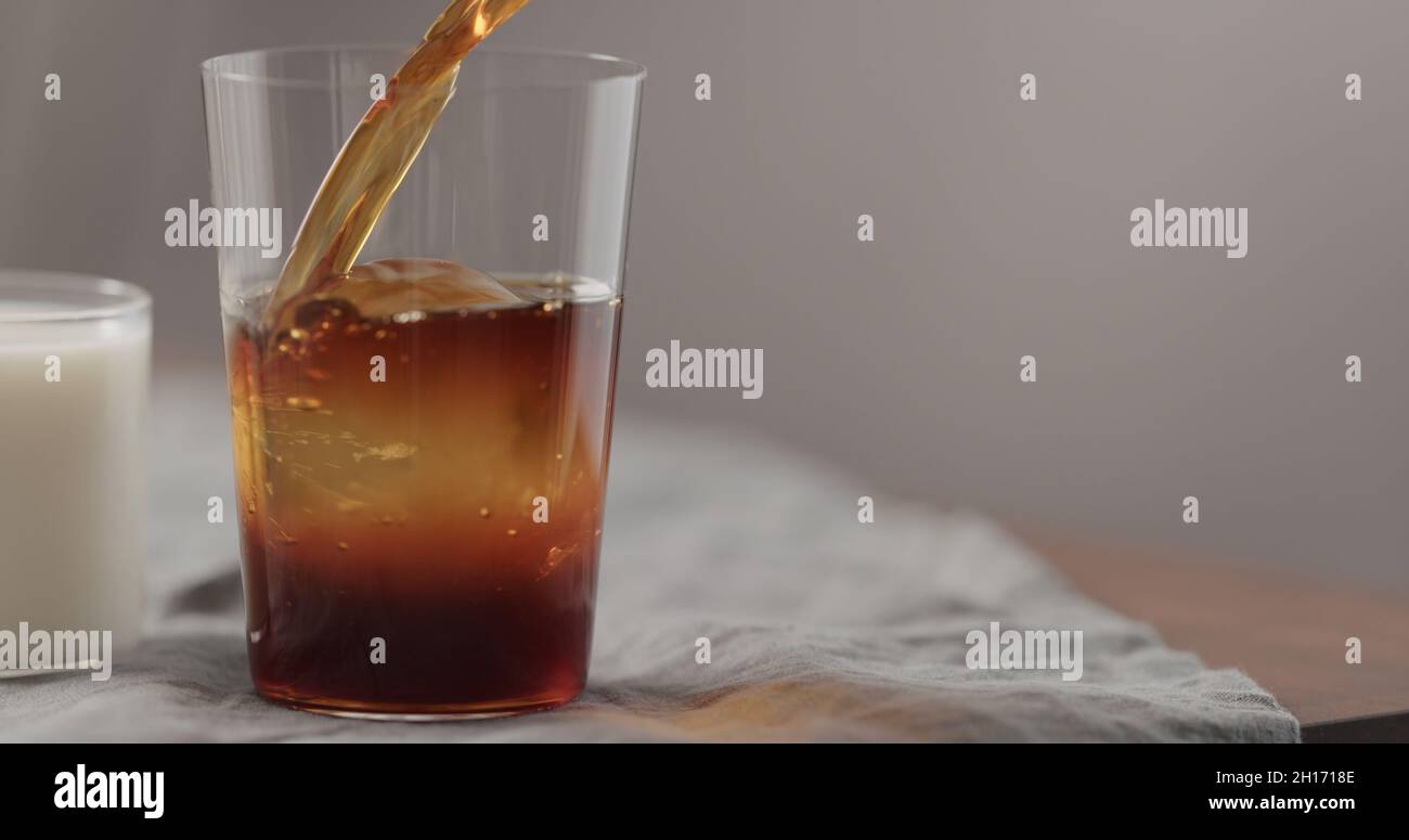 pour cold brew coffee in tumbler glass 