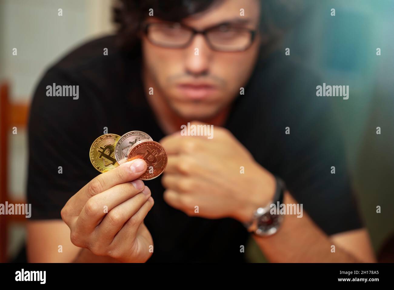 young man thinking to invest in bitcoin virtual currency Stock Photo