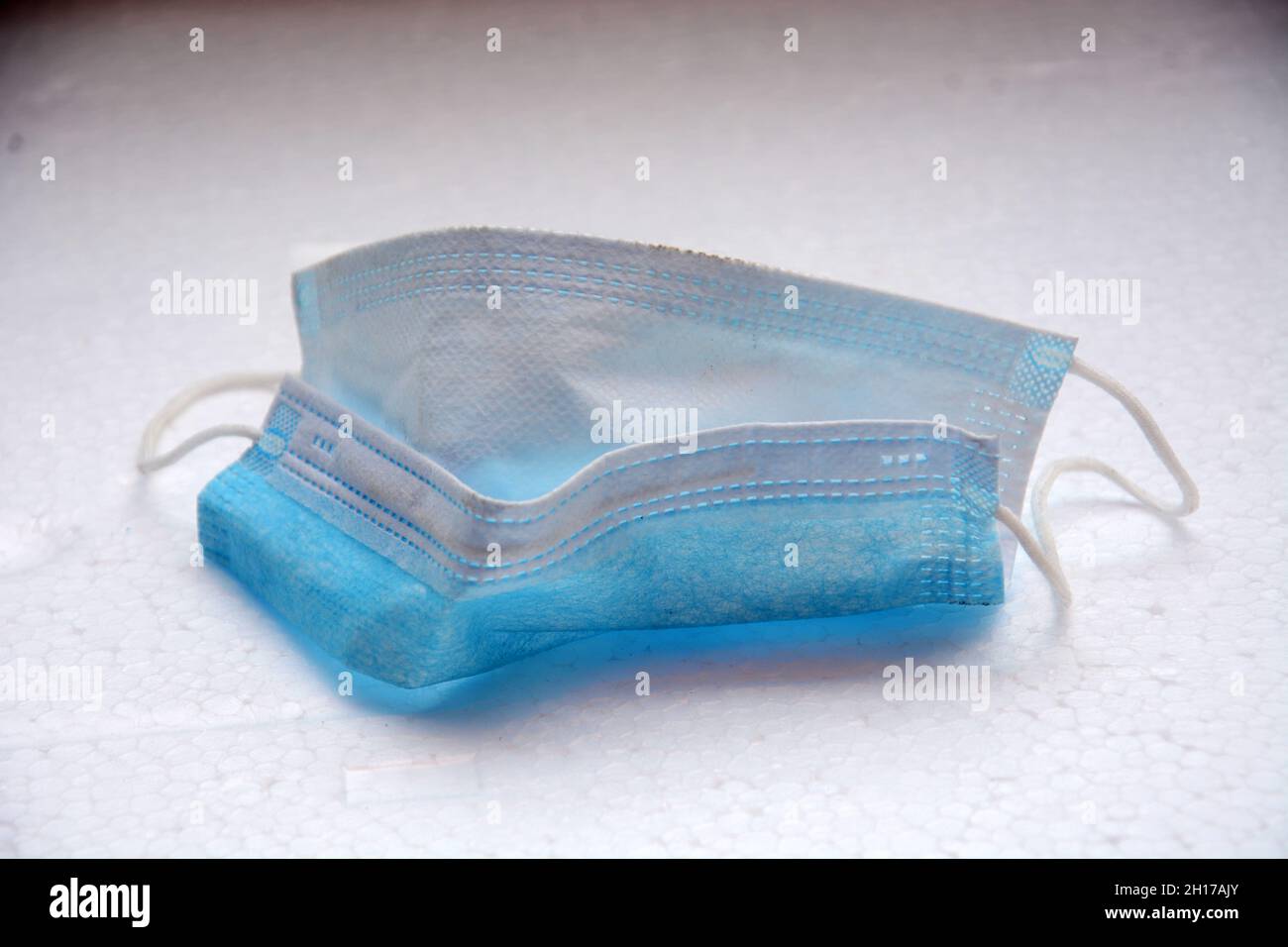 a blue medical mask that has been used Stock Photo - Alamy