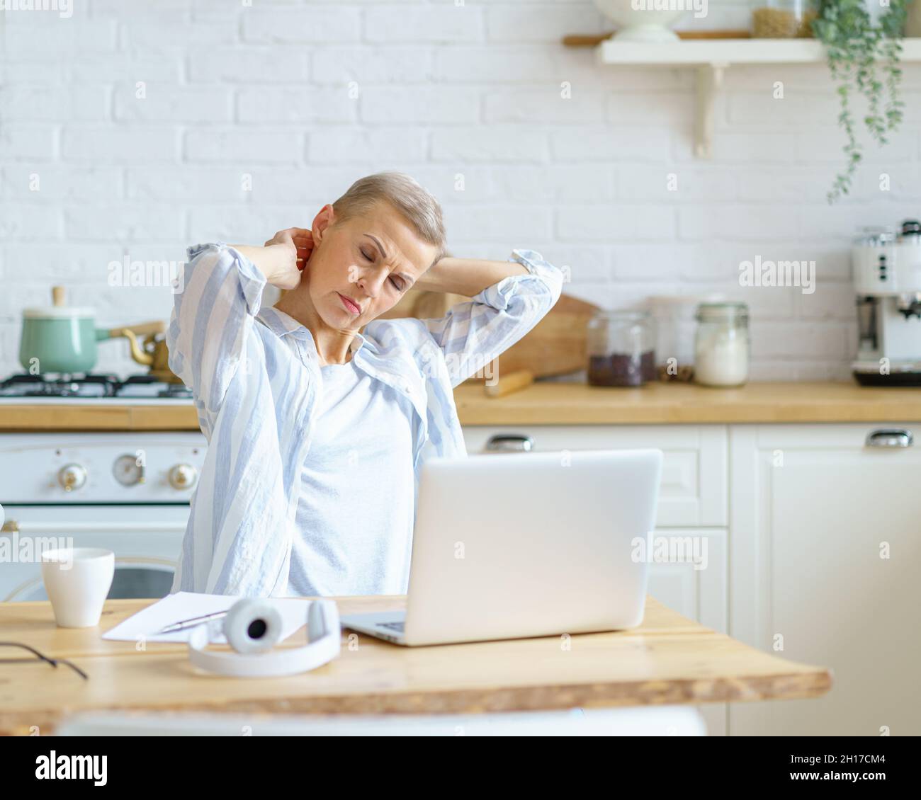 Woman in office feeling neck hi-res stock photography and images - Alamy