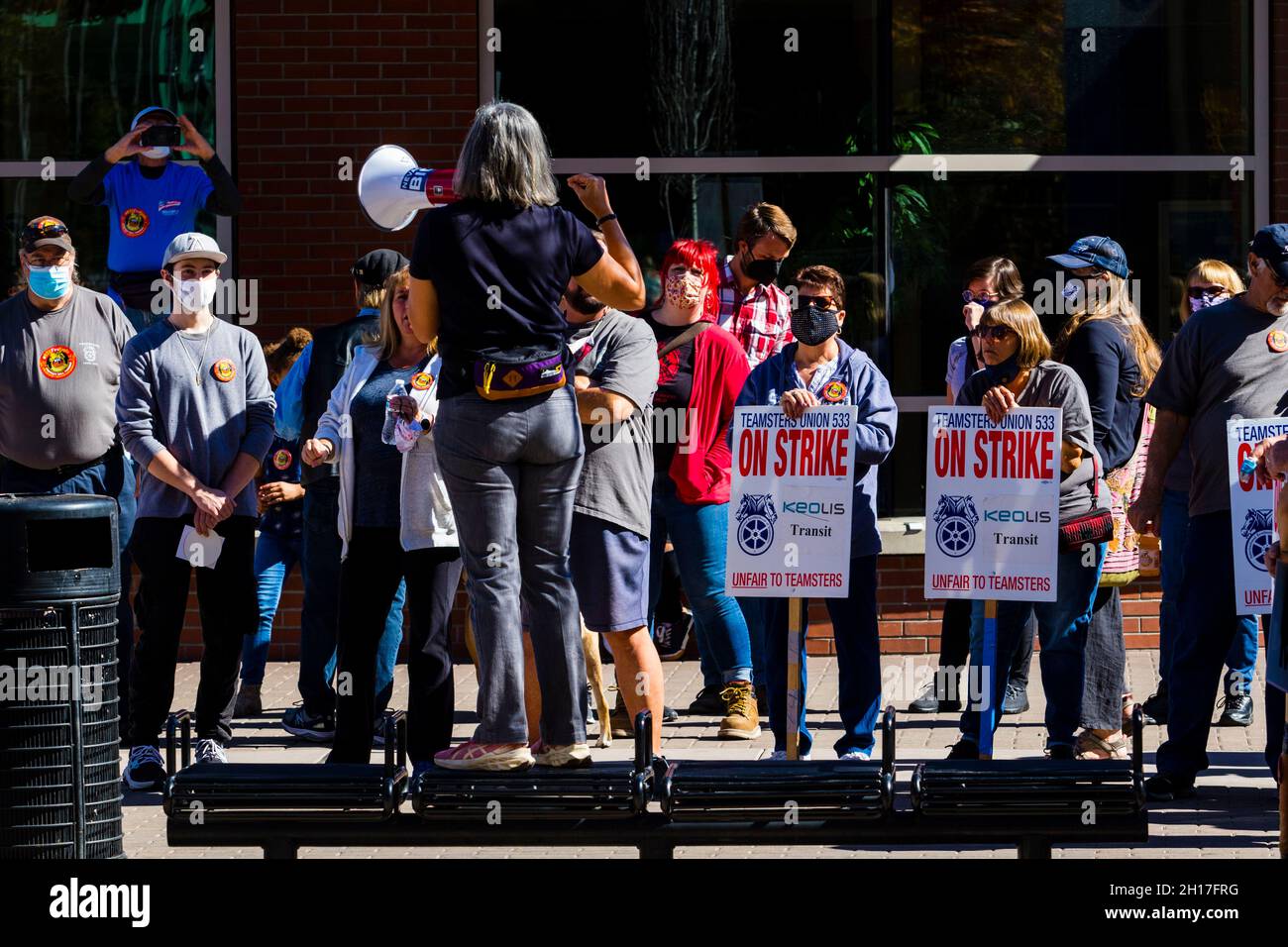 Union members on strike holding placards at a march listening to Jenny ...