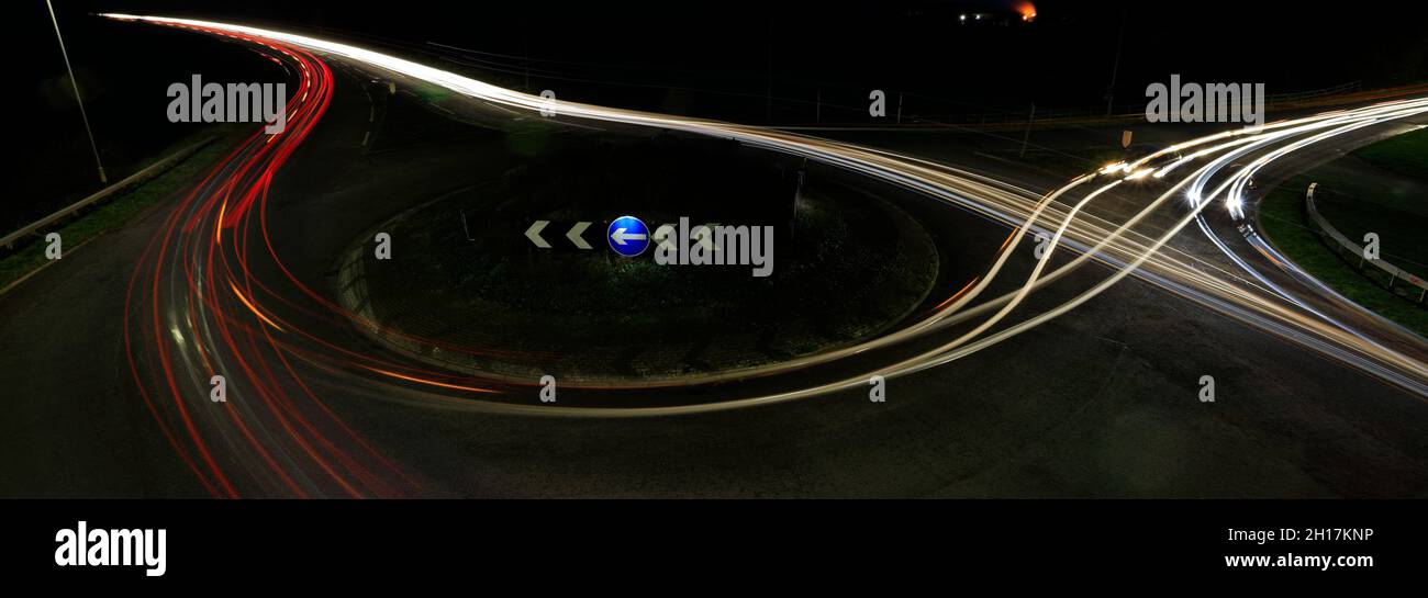 Nightime car trails at a roundabout, Peterborough City, Cambridgeshire, England; UK Stock Photo