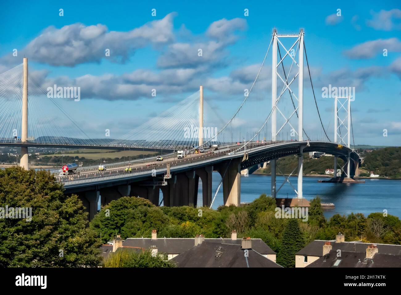 The old Forth Road Bridge with new Queensferry Crossing behind linking South and North Queensferry across Firth of Forth near Edinburgh in Scotland Stock Photo