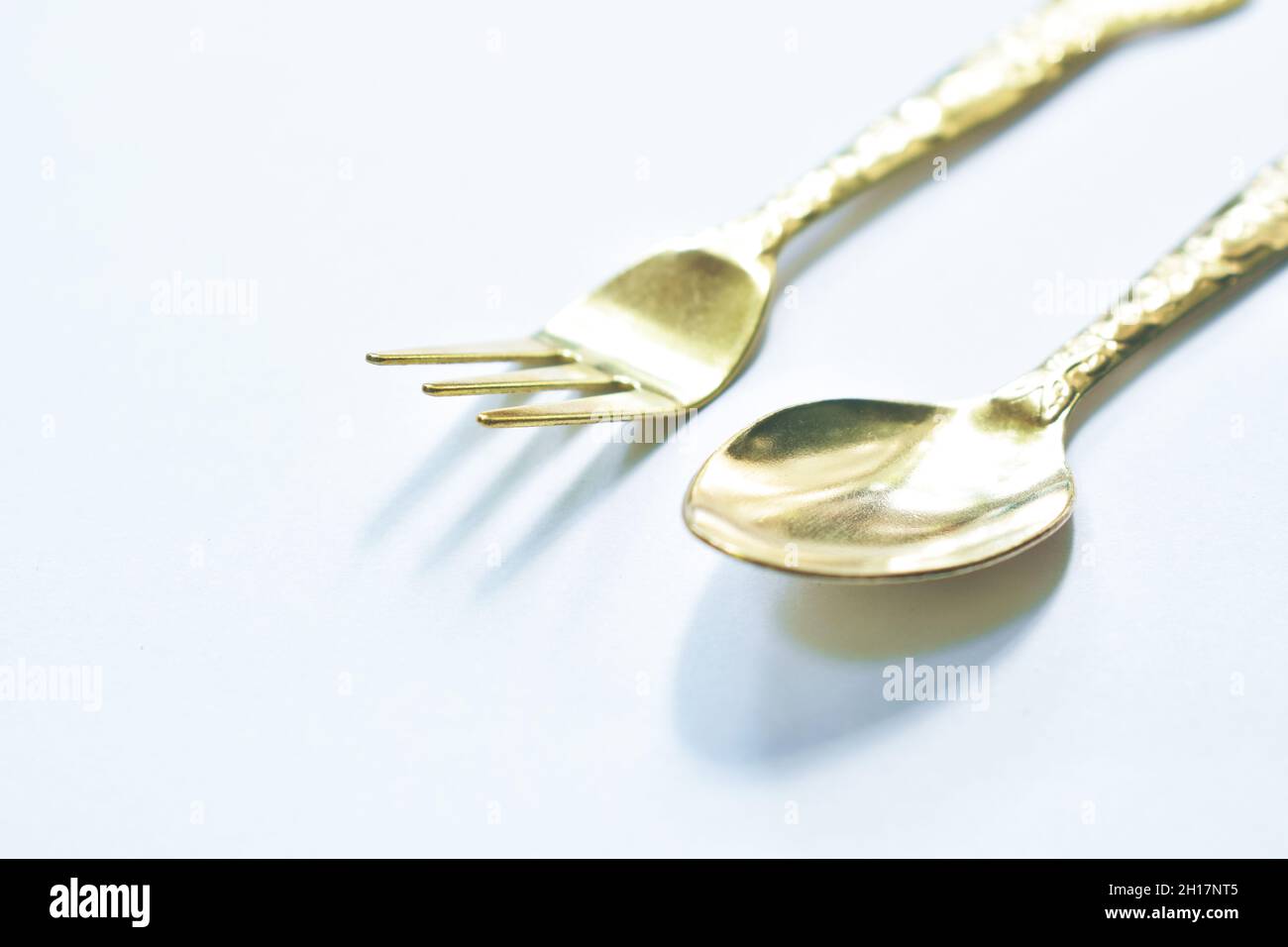 golden spoon and fork for on white background Stock Photo Alamy