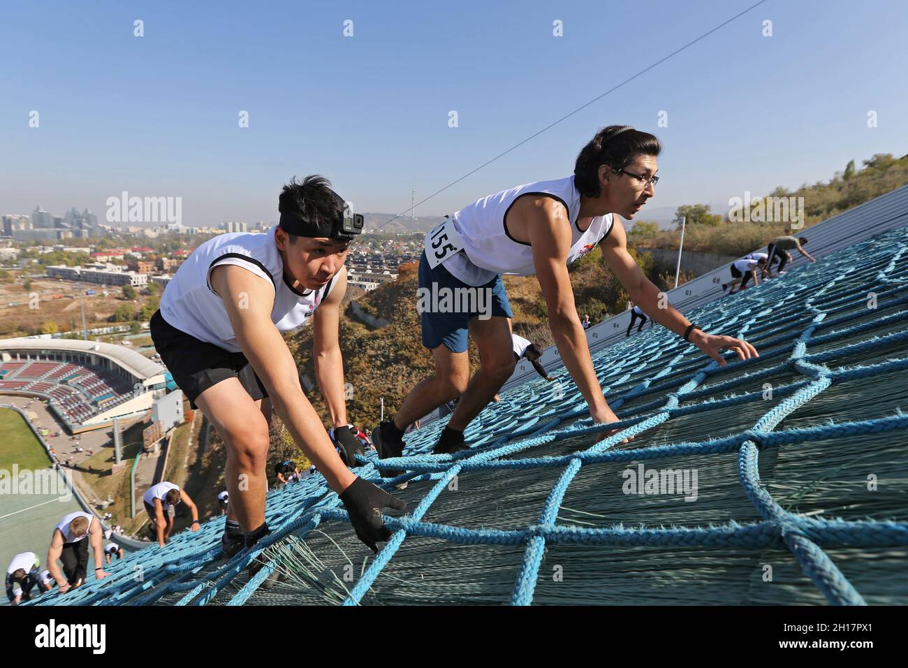 Athletes compete during the Red Bull 400 uphill sprint at the Sunkar  International Ski Jumping Complex in Almaty, Kazakhstan October 17, 2021.  REUTERS/Pavel Mikheyev Stock Photo - Alamy