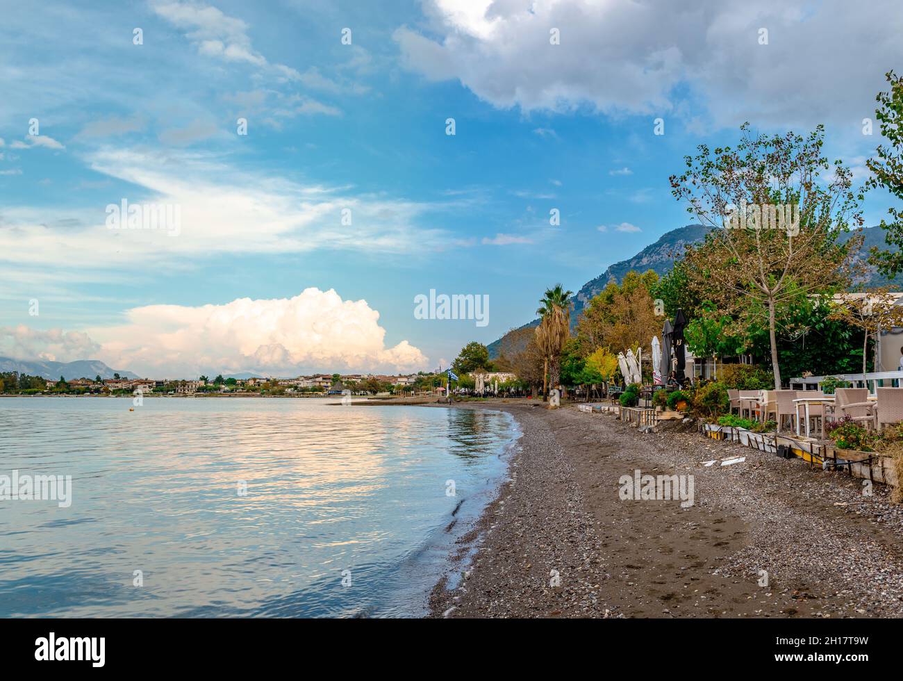 The empty beach in the autumn. Sunset dramatic sky, reflections on water. Stock Photo