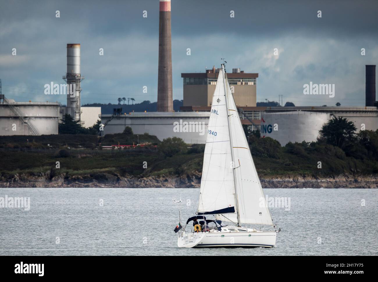 Cork Harbour, Cork, Ireland. 17th October, 2021. Yacht Snowdog passing the storage tanks at the oil refinery and generating station in Whitegate as it heads out for a day's sailing in Cork Harbour, Cork, Ireland. - Picture; David Creedon / Alamy Live News Stock Photo