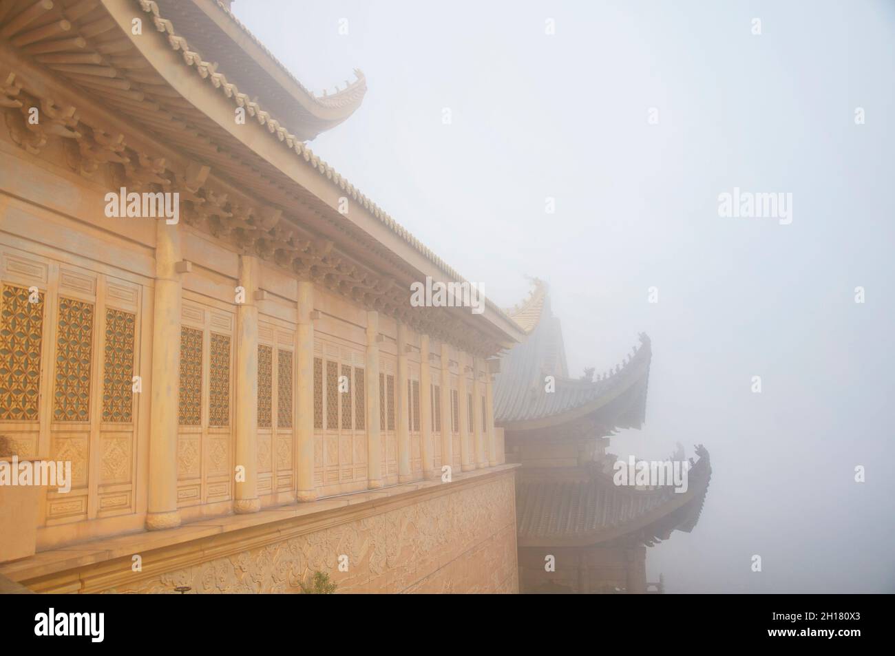The landmark golden hall atop mount emei or emeishan on a foggy morning in sichuan province china. Stock Photo