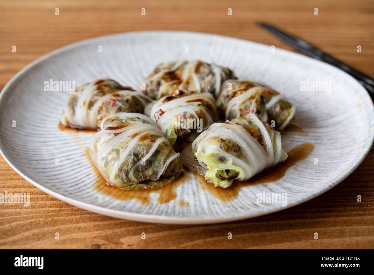 Chinese leaf parcels with mushroom filling in oyster sauce Stock Photo