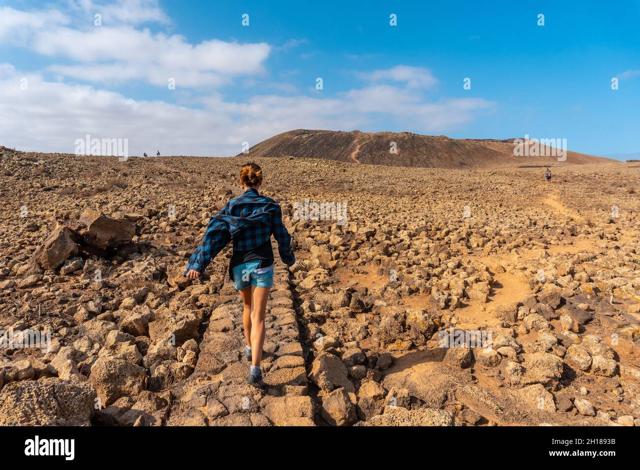 A young woman on the trail to the Crater of the Calderon Hondo volcano near  Corralejo, the island of Fuerteventura, Canary Islands, Spain Stock Photo -  Alamy
