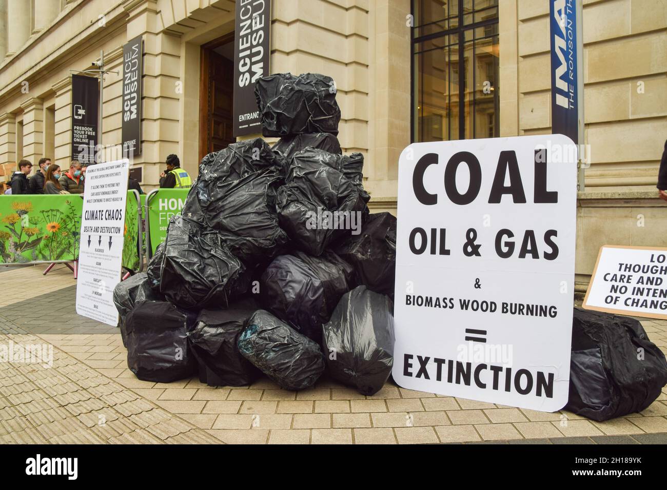London, UK. 17th Oct, 2021. Bags made to look like large lumps of coal outside the Science Museum. Extinction Rebellion activists gathered outside the museum in South Kensington ahead of the Global Investment Summit, taking place on 19th October, in protest against what they say is a 'greenwash platform' for some of the world's top polluters and companies financing fossil fuels. Credit: Vuk Valcic/Alamy Live News Stock Photo