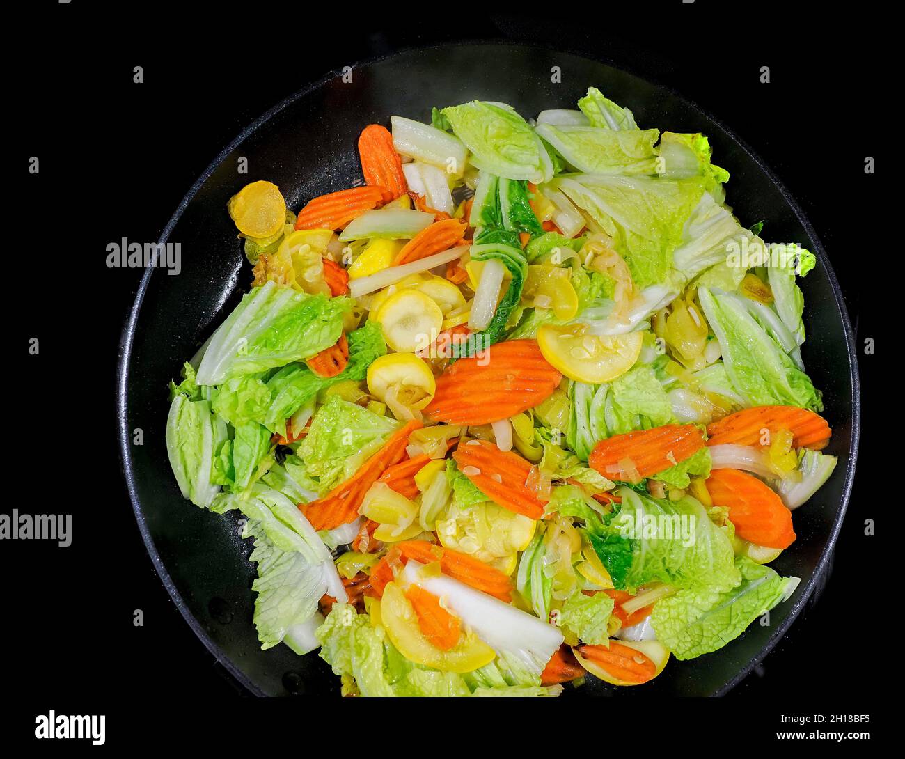 Cloae up of vegetable stir fry with carrots, onions, zucchine and