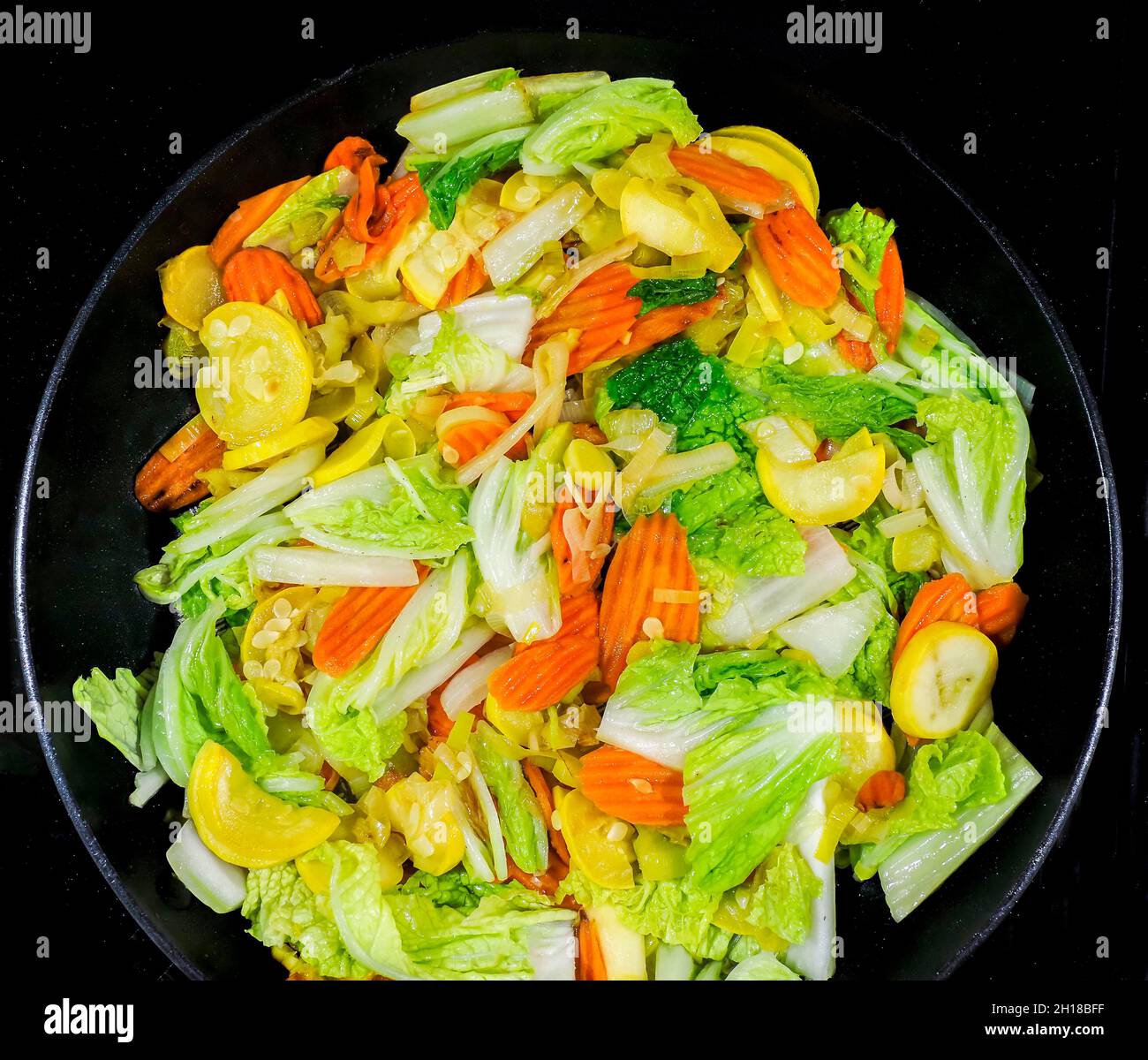 Cloae up of vegetable stir fry with carrots, onions, zucchine and