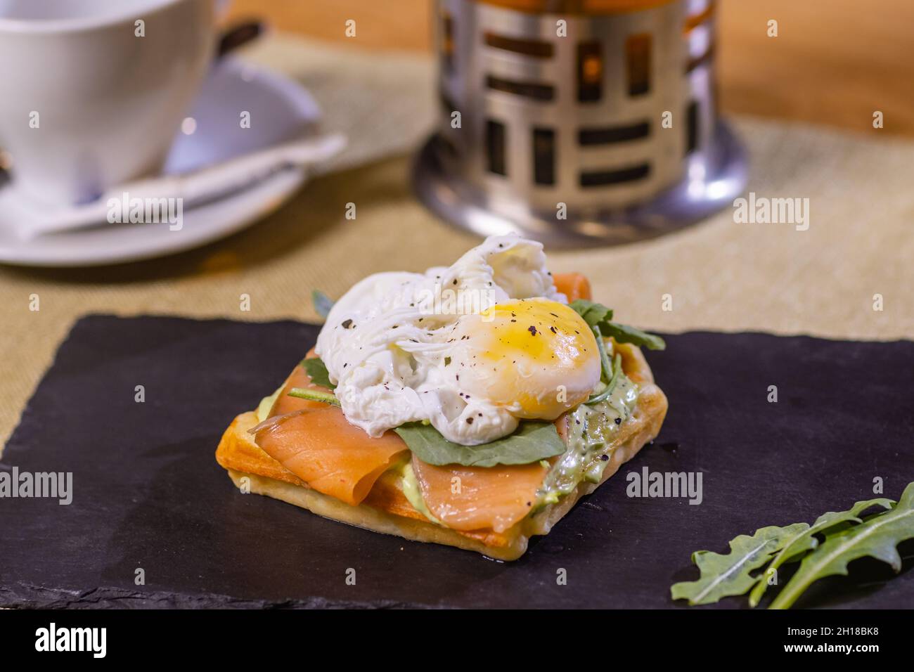 Poached egg on toast, with smoked salmon, avocado, grilled tomato, and