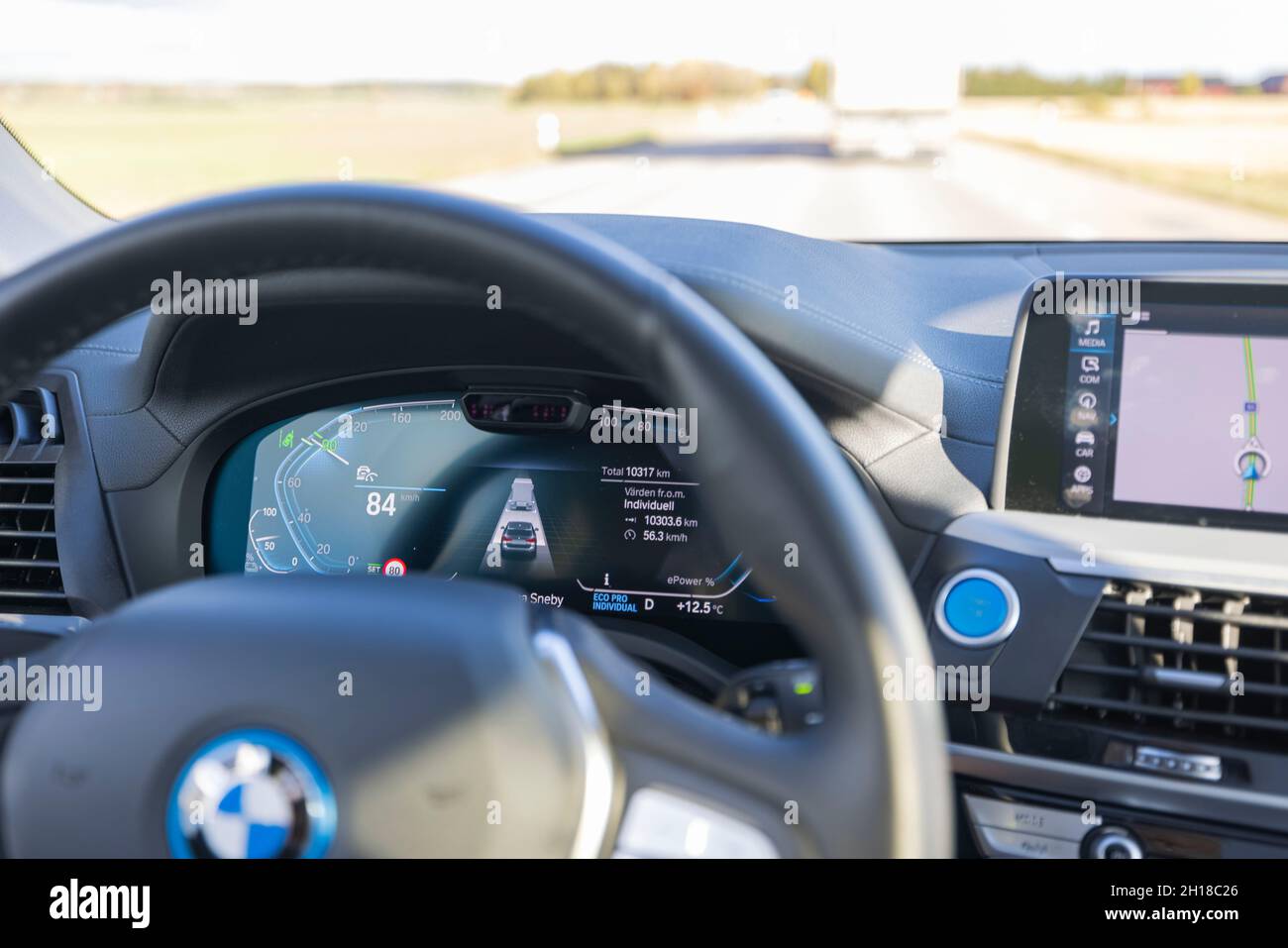 Close up interior view of electric car BMW iX3 dashboard and steering ...