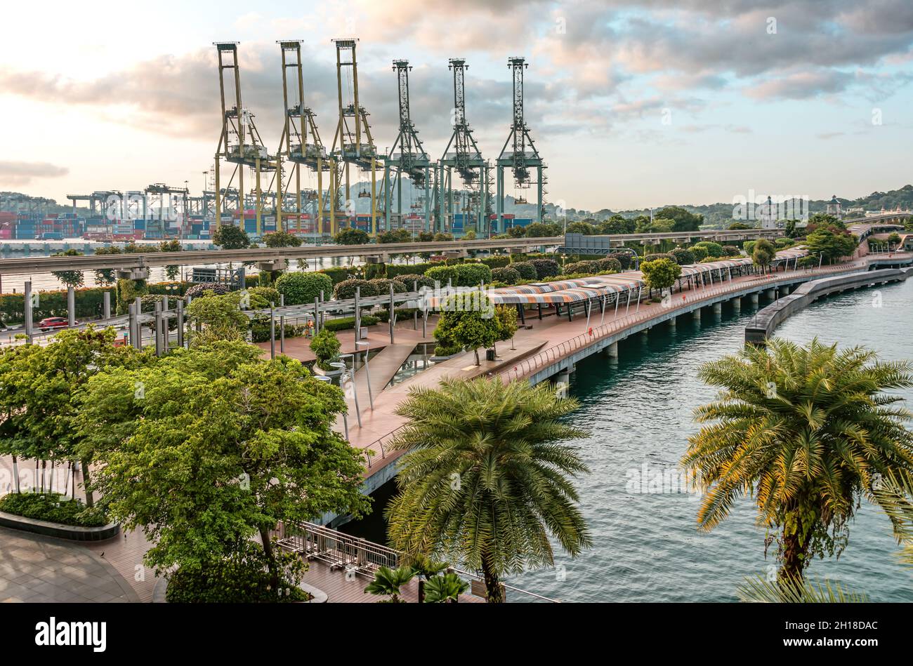 Boardwalk to Sentosa Island Resort with the cargo port at the background, Singapore Stock Photo