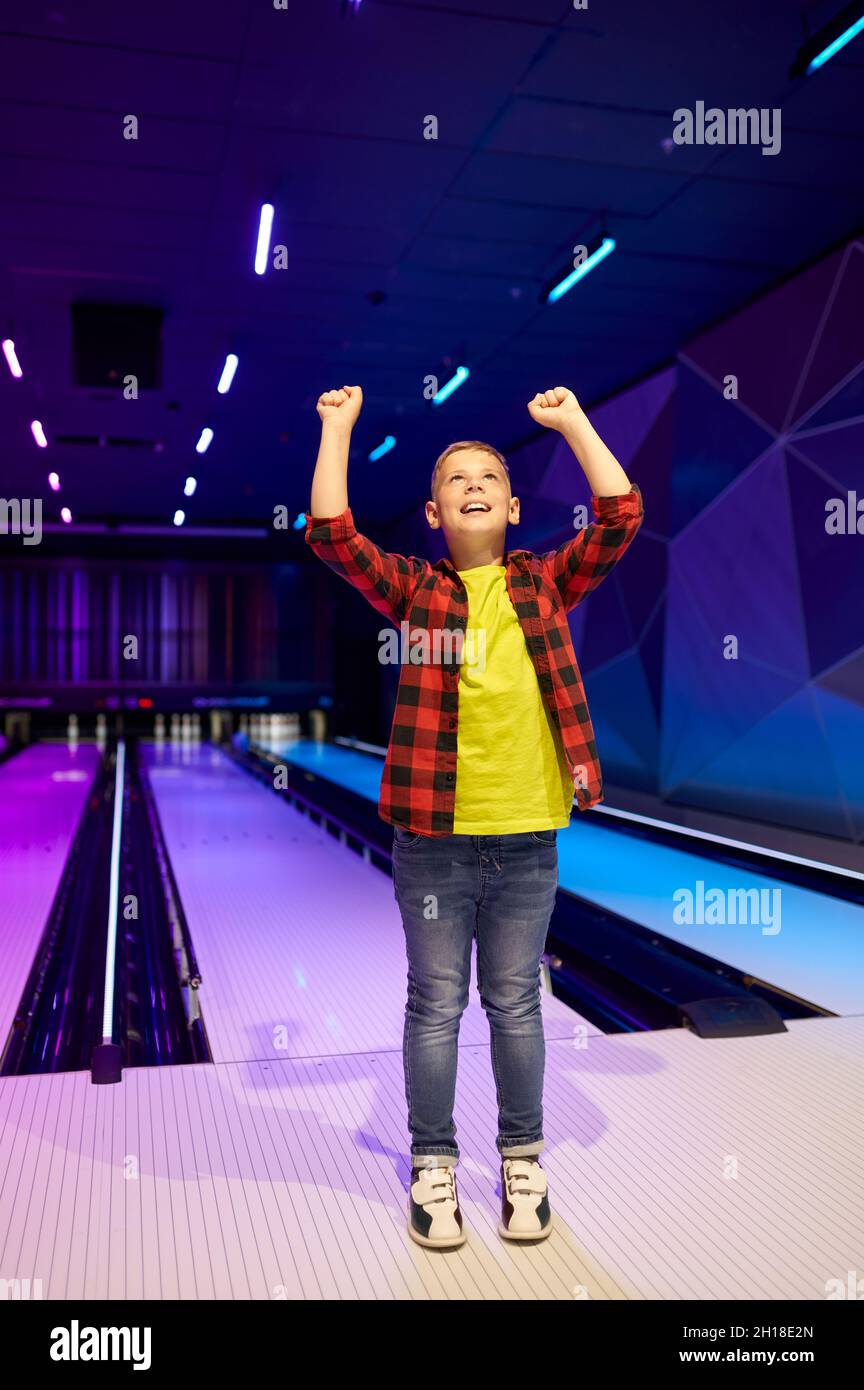 Boy playing bowling, happy little bowler Stock Photo