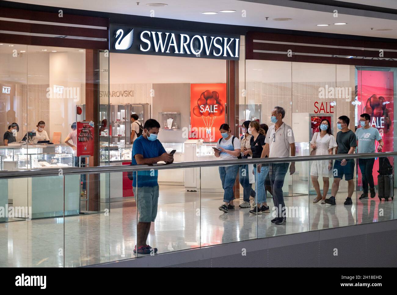 Shoppers walk past the Austrian jewelry producer and luxury brand Swarovski  store at Tung Chung district in Hong Kong. (Photo by Budrul Chukrut / SOPA  Images/Sipa USA Stock Photo - Alamy