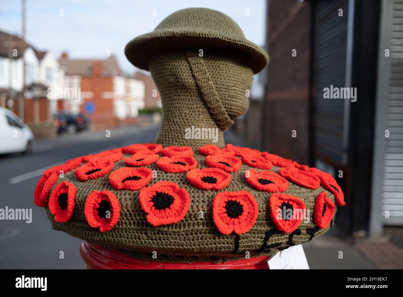 New Brighton UK October 2021 red poppy fund raiser royal british legion appeal on top of red postal boxes with knitted tommy and helmet Stock Photo