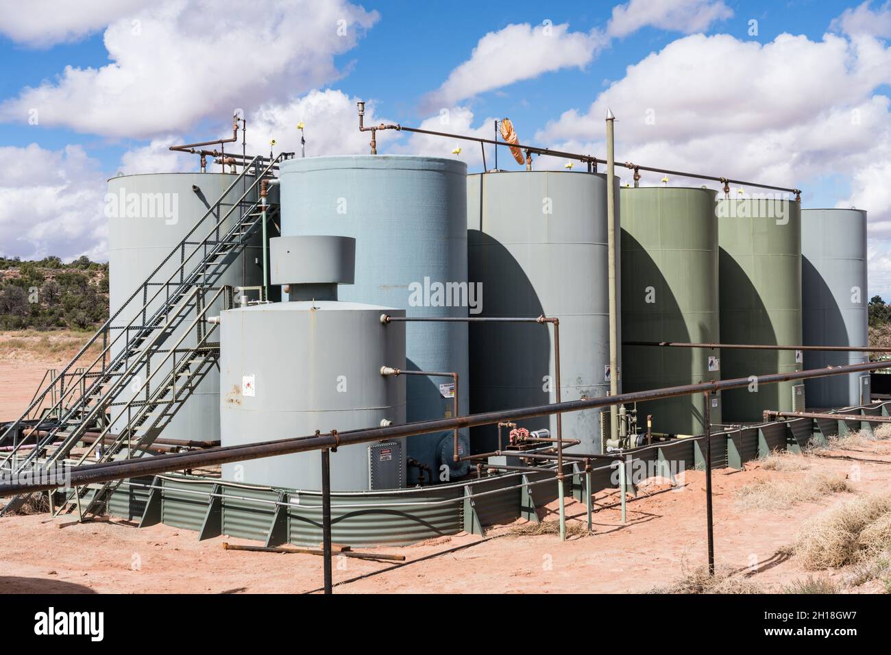 A crude oil storage tank battery for collecting oil from wells before  transporting by truck to a refinery Stock Photo - Alamy