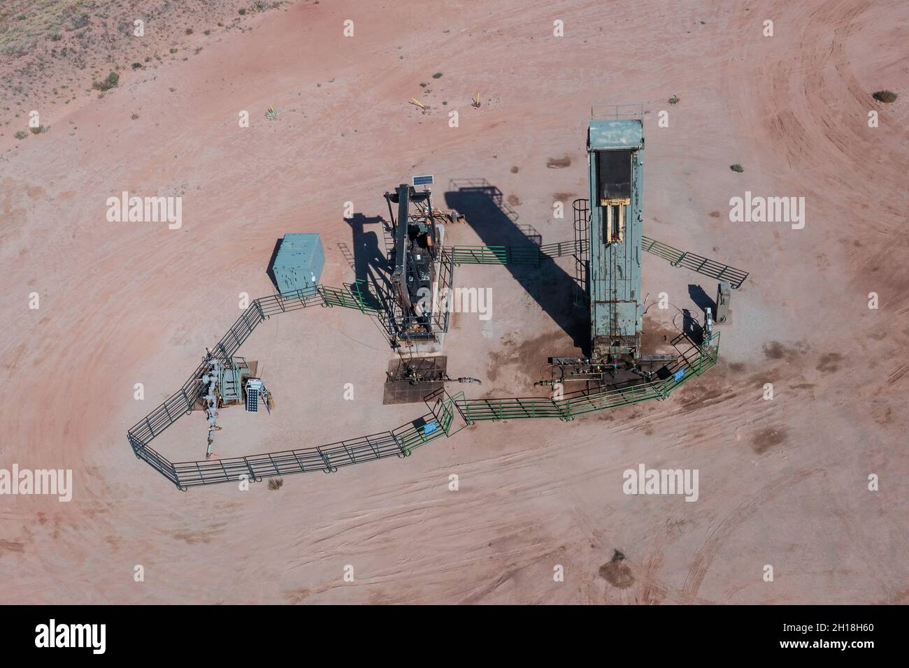 A horsehead pump jack and a long stroke belt driven pumping unit on a