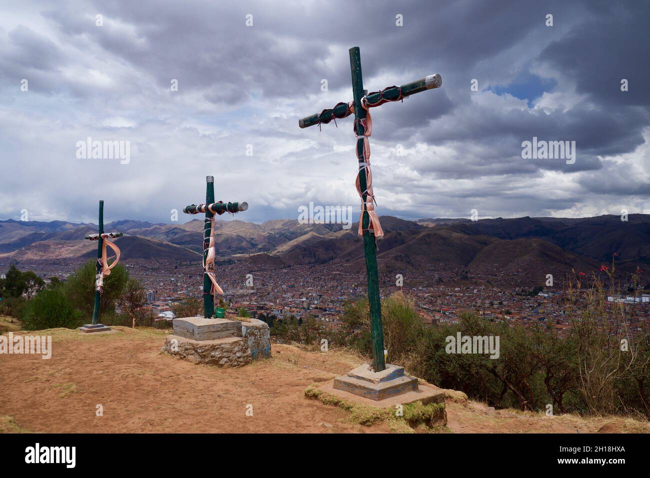 Yhree crosses near Cristo blanco, Jesus Christ sculpture at Sacsayhuamán Inca fortress above Cusco, Peru Stock Photo